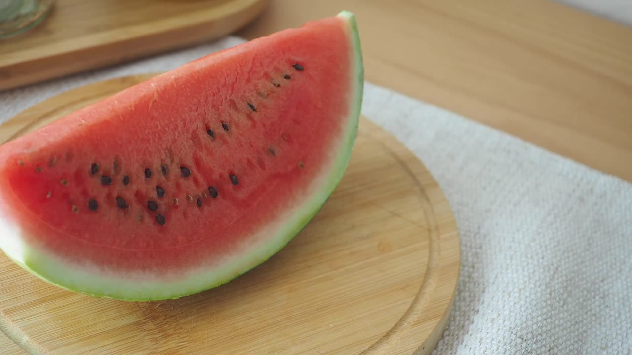 A slice of refreshing watermelon on a wooden board