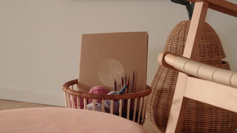 knitting equipment in a basket wool and needles sunlit living room