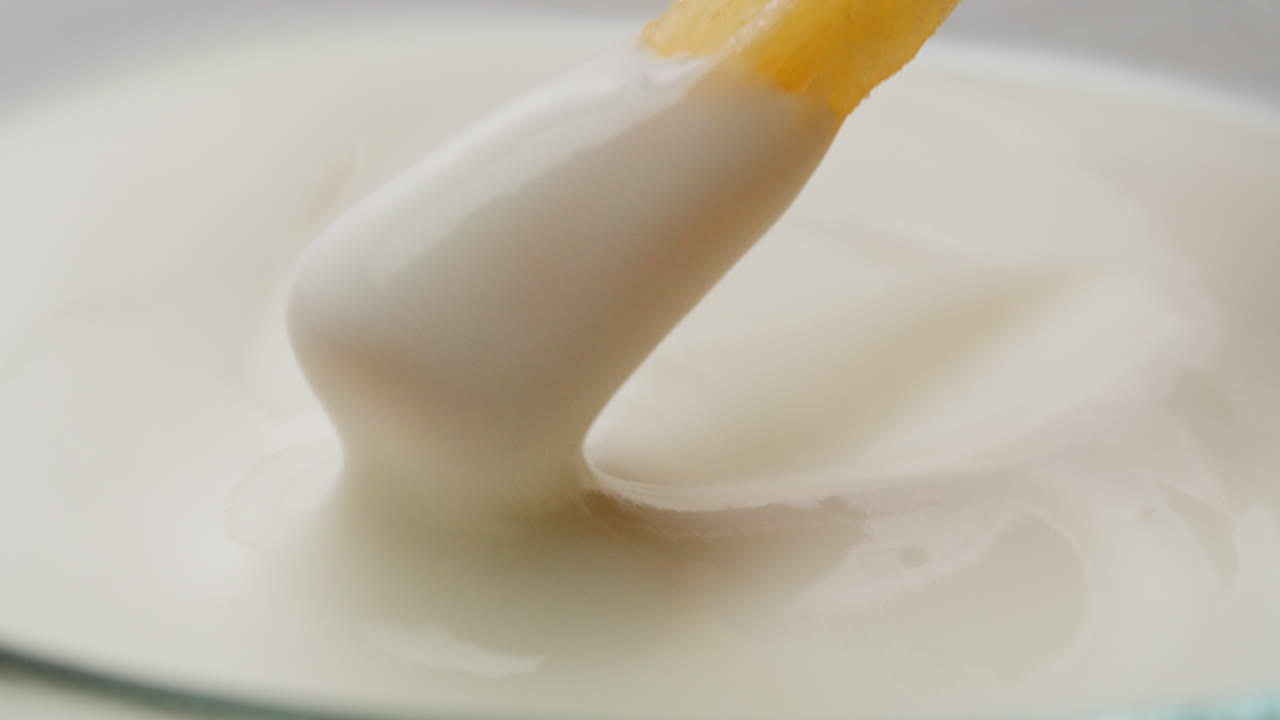 French Fries Dipping in Dairy Sauce