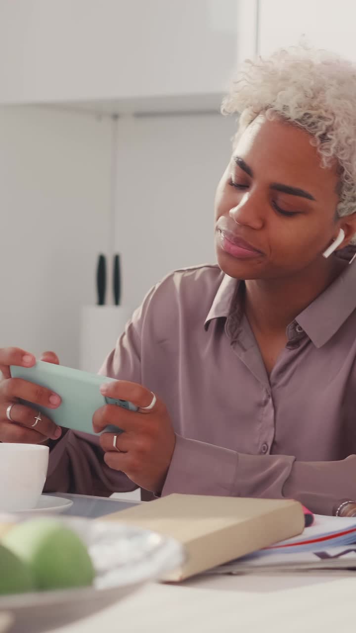 Enjoying a peaceful moment with a smartphone in a modern kitchen