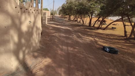 point of view of a vehicle arriving at a village in the sahara desert