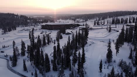 drone shot sunrise over ruka ski resort and mountains in lapland