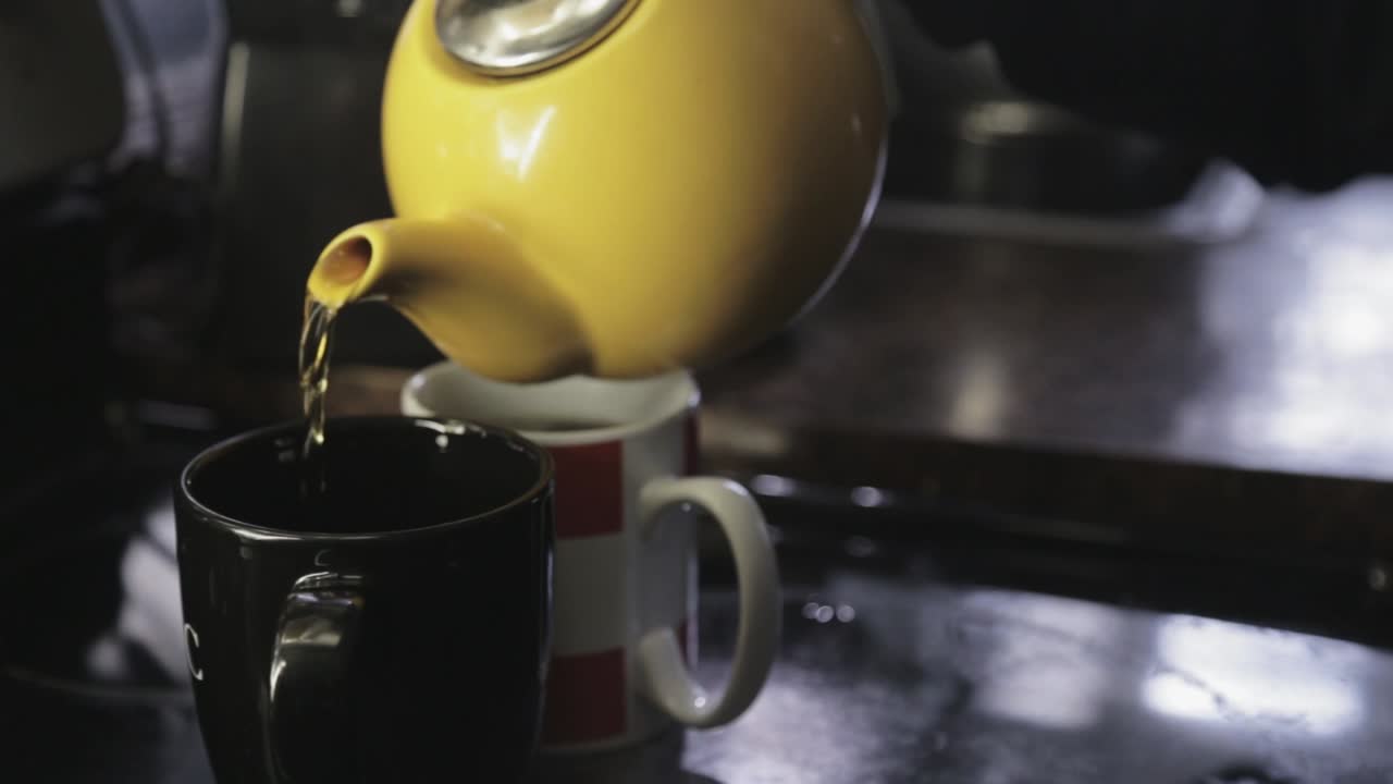Slowly Pouring A Hot Tea On A Tea Cup - Close Up Shot