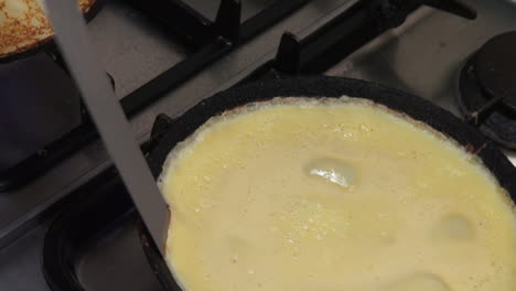 Shot-of-a-cook-making-pancakes-on-a-stove