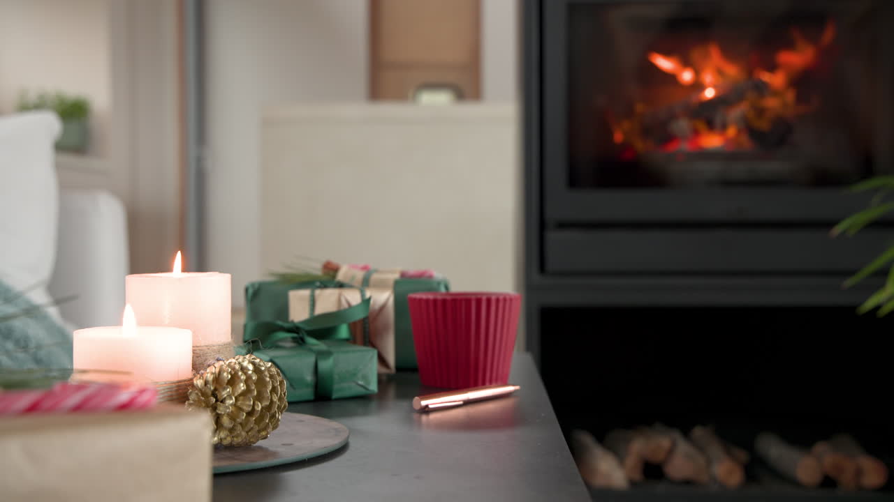 Cozy Christmas scene with candles, gifts, and fireplace creating warm ambiance, copy space