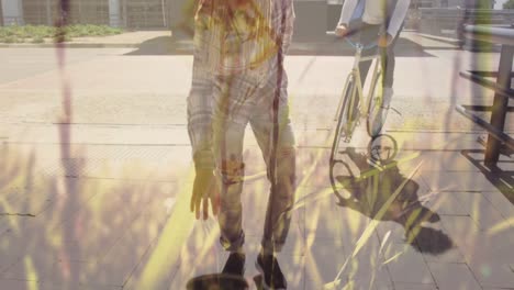 animation of grass over diverse people riding bike and skateboarding