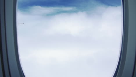 view through airplane window, sky over the clouds - flight from australia to singapore - aerial, pov