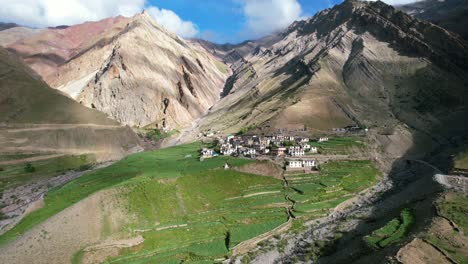 wide-panoramic-aerial-of-jagged-rocky-mountains-surrounding-Mud-Village-in-Pin-Valley-on-sunny-summer-day