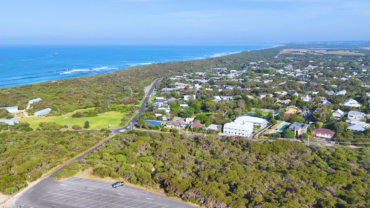 Aerial footage captures the serene coastal landscape of Point Lonsdale, showcasing lush greenery and ocean views under clear skies