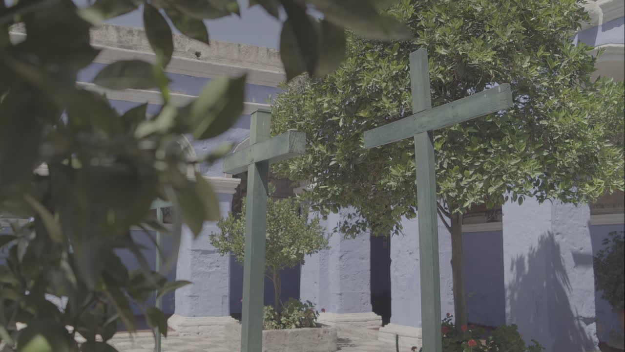 Moving shot of 3 wooden crosses inside the Santa Catalina monastery in Arequipa Peru LOG.