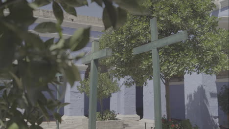 moving shot of 3 wooden crosses inside the santa catalina monastery in arequipa peru log.