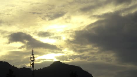 black stormy cloud on sunset golden yellow sky n communication antenna