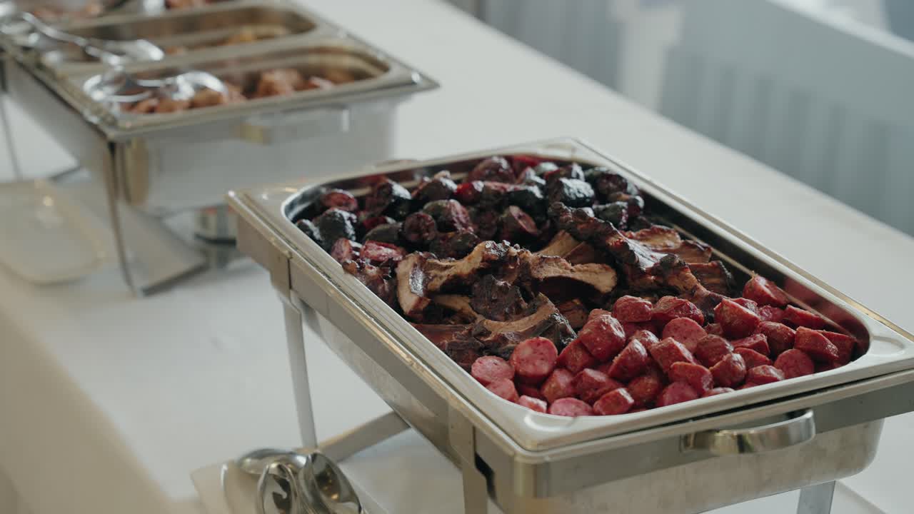 뷔페 트레이에 담긴 다양한 종류의 소시지와 조림 고기 모음