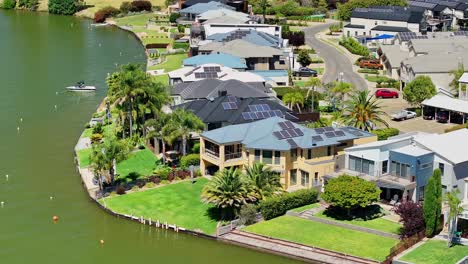 Close-aerial-circle-of-luxury-houses-on-the-lake-shore-of-Lake-Mulwala,-NSW,-Australia