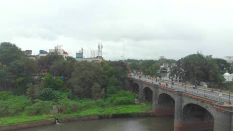 Rising-drone-shot-over-Shaniwar-wada-Chhatrapati-Shivaji-bridge-road-and-Dr-Hegdewar-chowk-on-a-cloudy-day-old-Pune-city-heritage-site-India