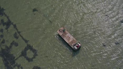 Oyster-barge-on-sea-drone-orbit-upward