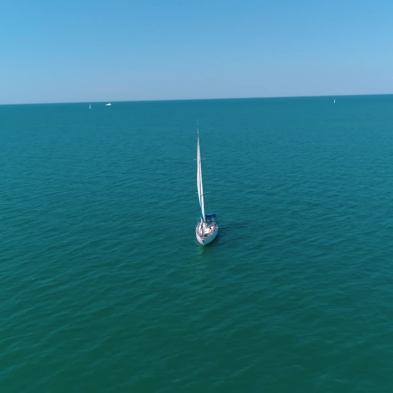Seascape with sail boat. Aerial view of lonely ship sailing in the open sea