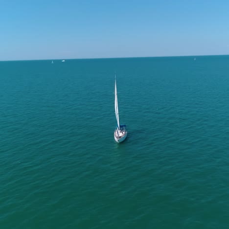 seascape with sail boat. aerial view of lonely ship sailing in the open sea
