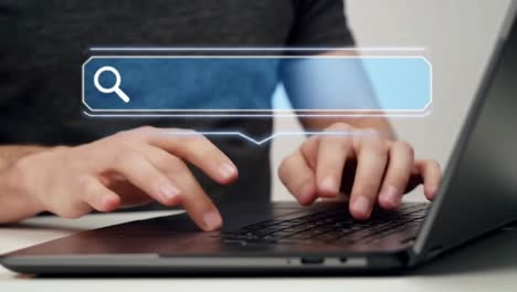 close-up of a man's hands using the trackpad on a laptop computer