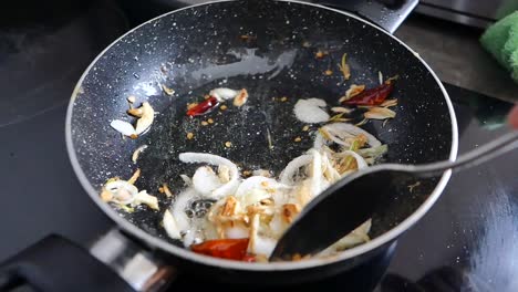 cooking onions and garlic in a pan