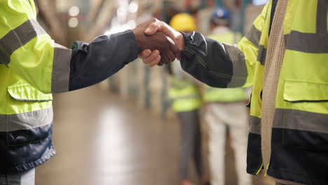 handshake between workers in a warehouse