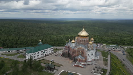 aerial view of a monastery complex in a forest