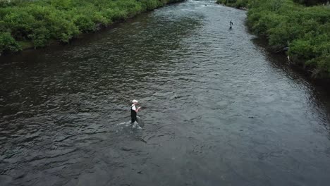 drone shot above a man fly fishing in the provo river in the mountains of utah-1