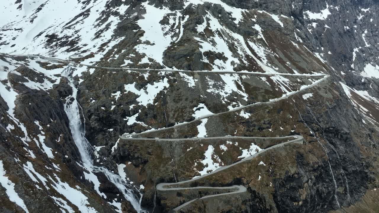 Serenity in Motion - Trollstigen road Majestic Beauty during Early Spring with massive waterfall close to road