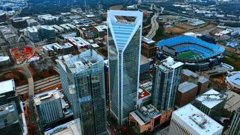 flying around the magnificent skyscrapers with mirror windows in the downtown of charlotte, north carolina, usa. city scenery on cloudy daytime