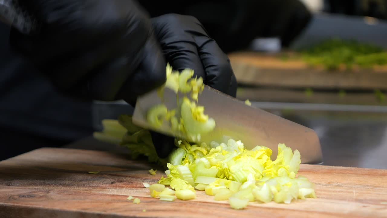 The chef slices celery into thin slices