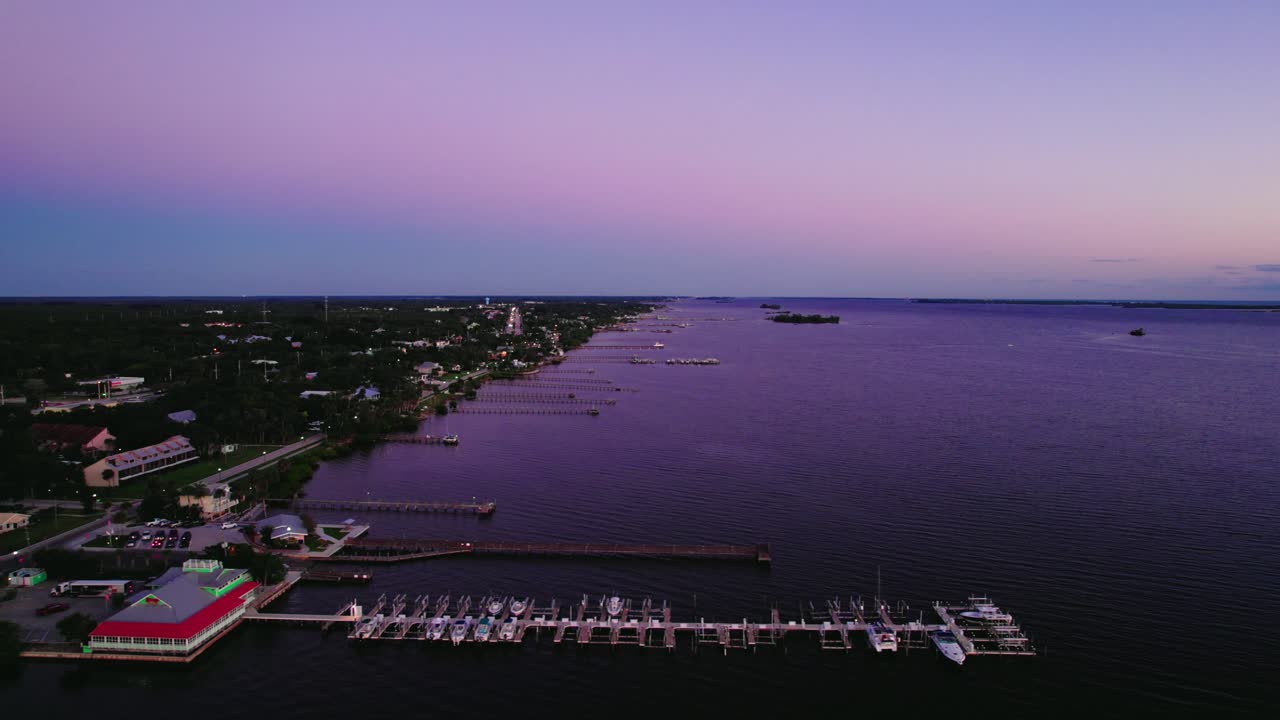 A tranquil morning at Sebastian's Yacht Club, captured in a serene aerial sunrise, exuding marine elegance and coastal charm