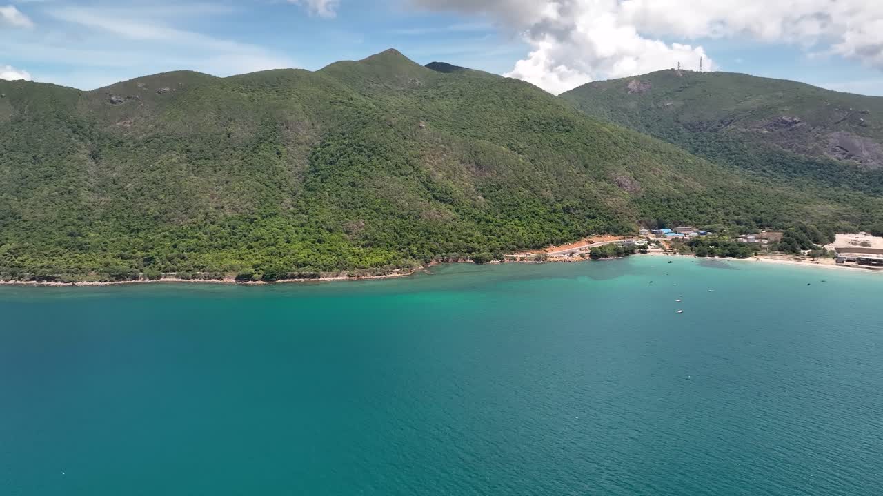 Panoramic View Of Blue Sea, Green Hills On A Sunny Day In Con Dao Island In Vietnam. - aerial shot