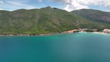 panoramic view of blue sea, green hills on a sunny day in con dao island in vietnam. - aerial shot