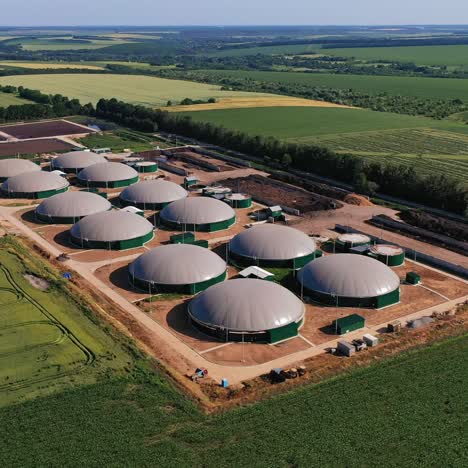 biogas complex in the green plantations. biogas storage tanks from the air perspective. beautiful nature scenery at the backdrop