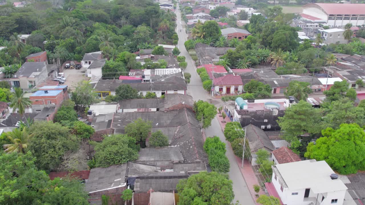 Bathed in daylight, the drone soars smoothly over the rooftops of the neighborhood, revealing a vibrant patchwork of colors and textures.