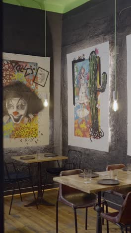 quirky restaurant interior with clown and cactus wall art