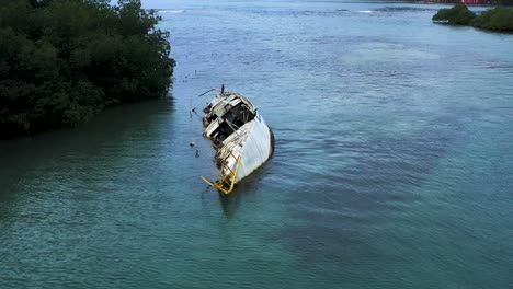 Closeup-aerial-view-above-broken-sunken-abandoned-shipwreck-on-Panama-island-coastline