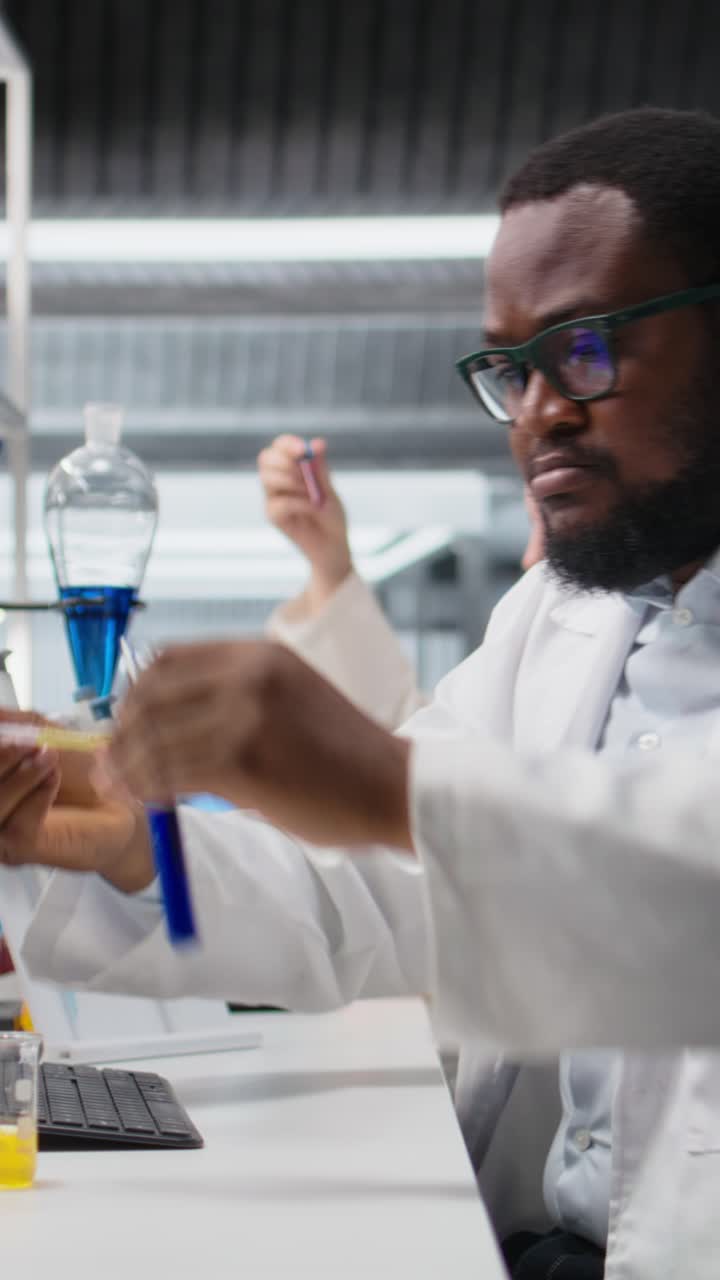Vertical video Histology chemist conducting pipetting operation for chemical liquids