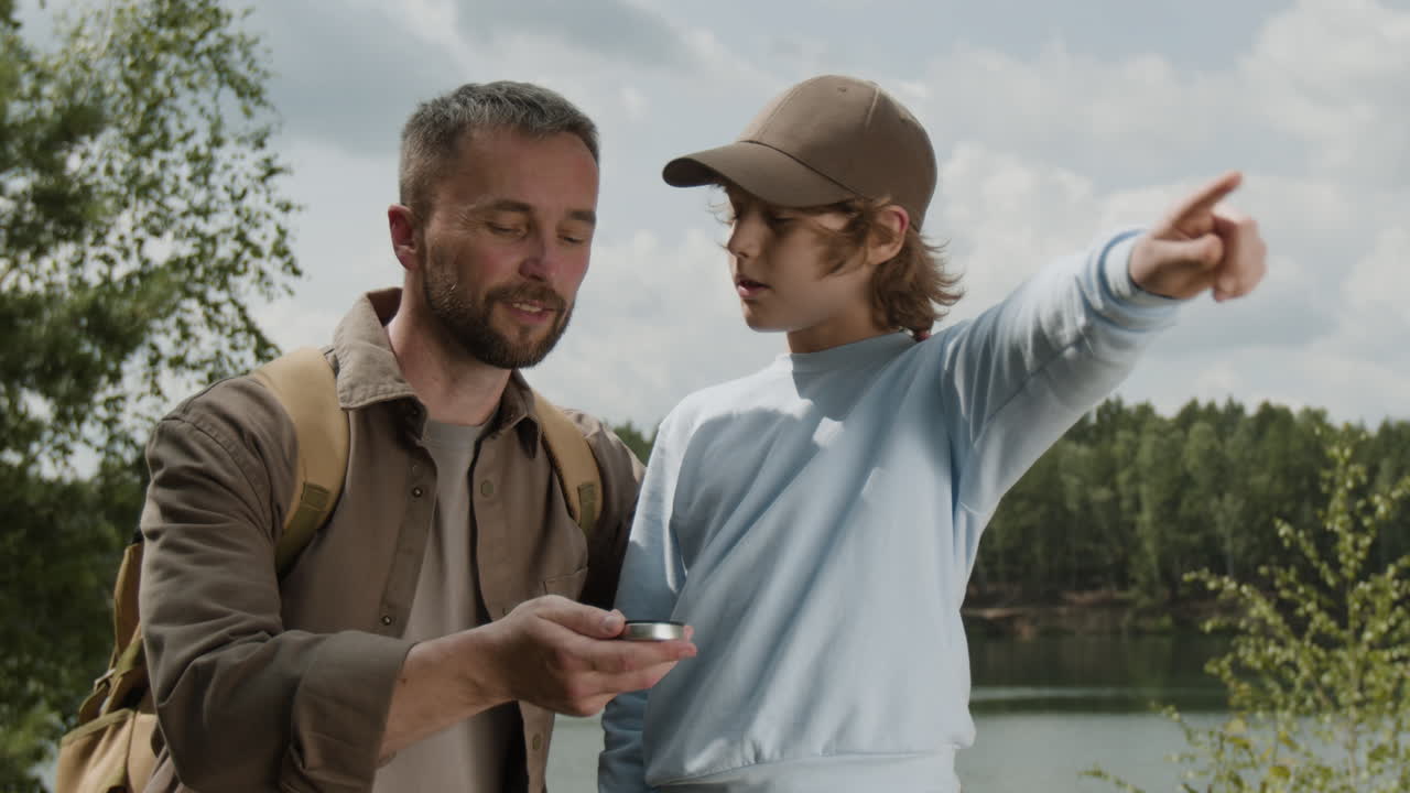 Father and Son Exploring Nature with Compass