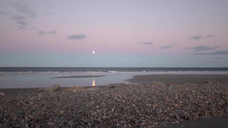 empty beach on the atlantic ocean during a december full moon, corona effects