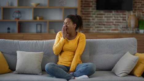 woman yawning on a couch