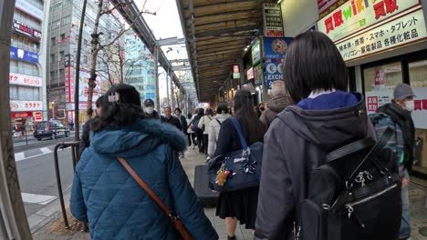 pedestrians navigating a busy urban sidewalk