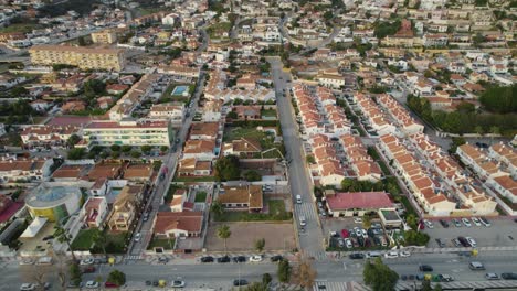 aerial shot advancing over the city in malaga, spain: buildings, houses and a construction site with a crane