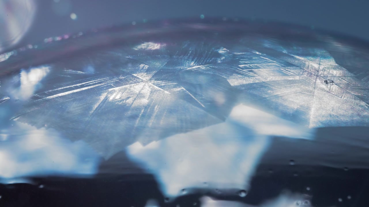 Abstract freezing ice pattern covering the soap bubble in winter