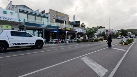 person crossing road in lorne, australia