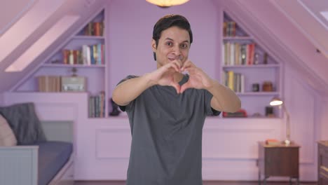 happy indian man showing heart sign