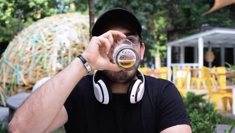 Young-man-takes-a-long-drink-of-his-beer