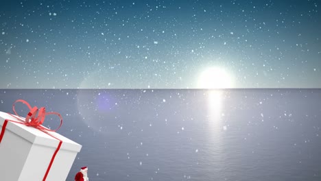 Animation-of-santa-claus-carrying-huge-christmas-gift-and-snow-falling-in-winter-landscape