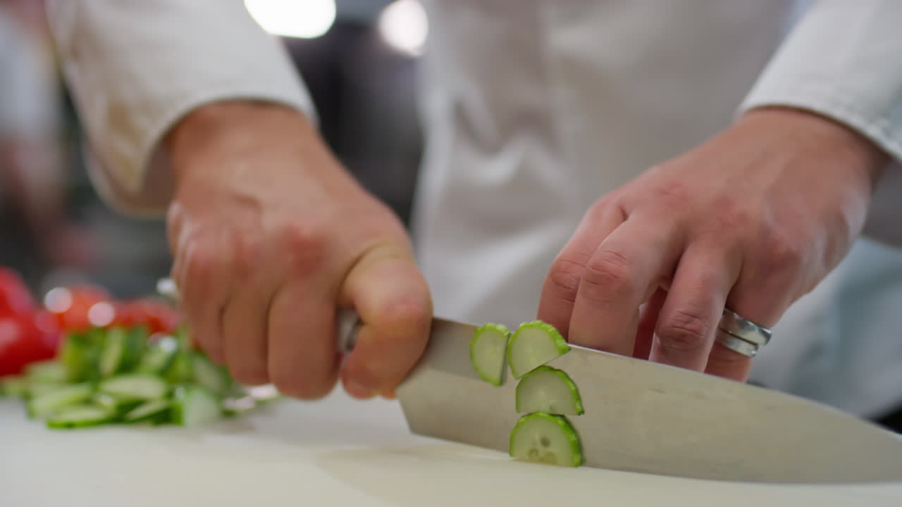 Hands of Chef Cutting Fresh Cucumber