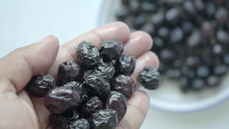 close-up of black olives in hand